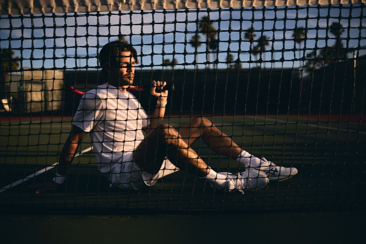 A tennis player gazing at the sunset on court at CC Tennis Club, Cathedral City CA